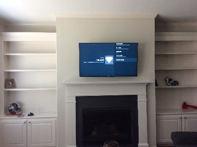 One of our many TV installations over the fireplace.