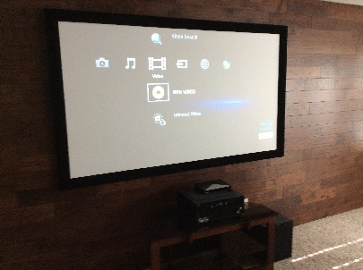 Home Theater System with elegant wood wall.