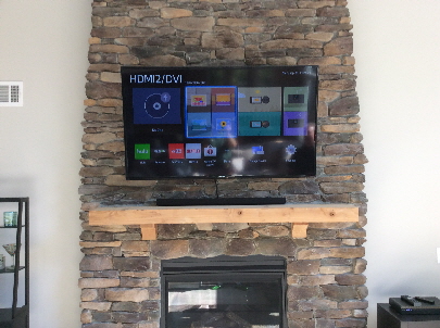 Another nice job of installing a 65" TV with a sound bar on a stone fireplace.